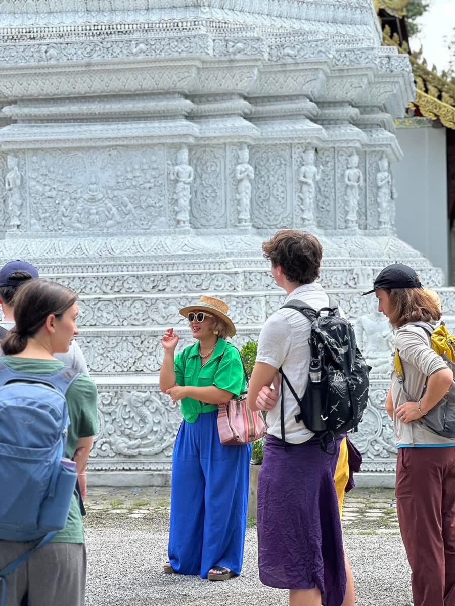 Food walk group at a white temple chedi in Chiang Mai